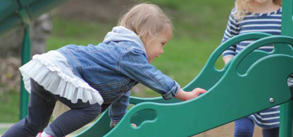Little girl climbing the slide